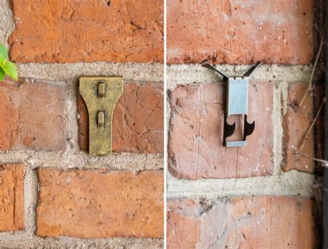 metal bracket behind brick wall|hanging things from brick wall.